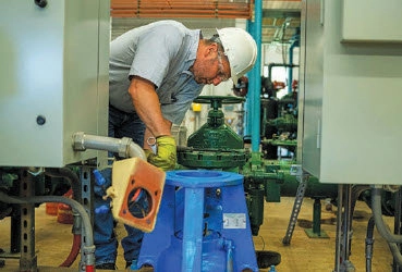 Mike Hopf Working on a Water Pump at the Villages Water Treatment Plant copy.webp